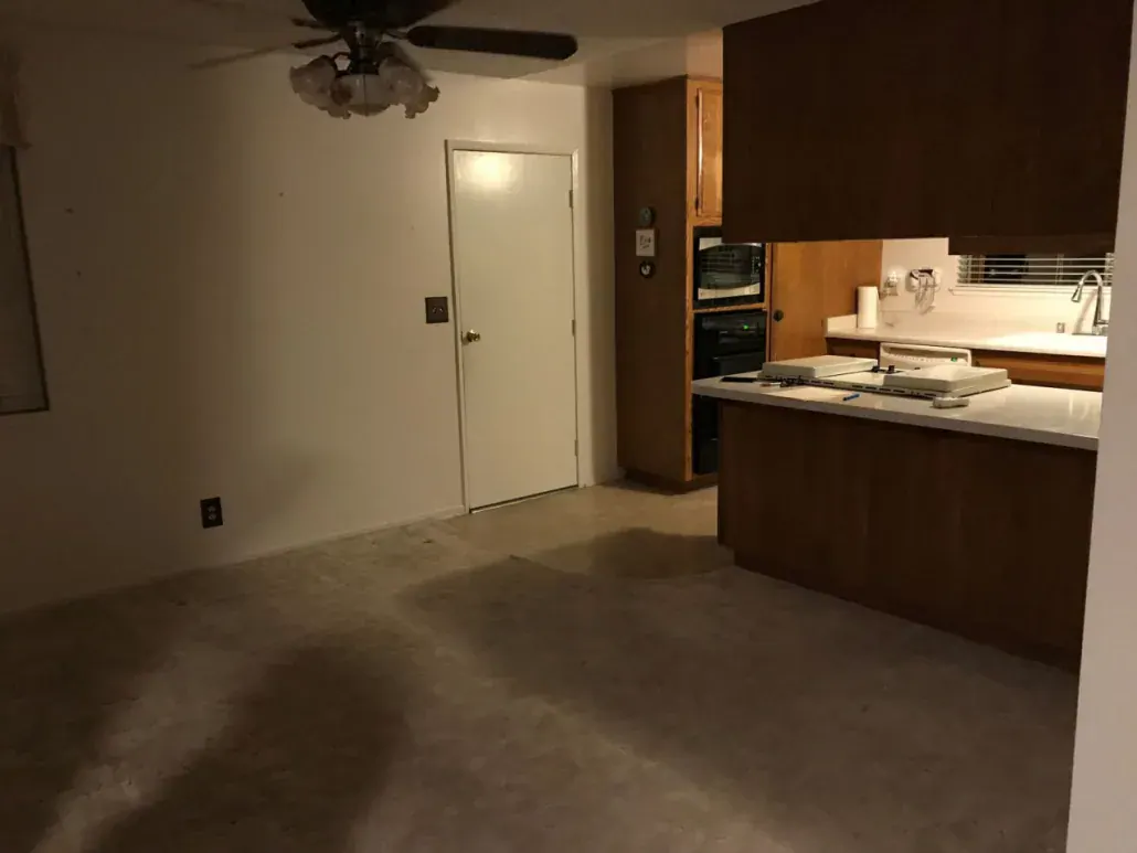 Kitchen remodel in progress with espresso cabinets, a peninsula countertop and a new interior door