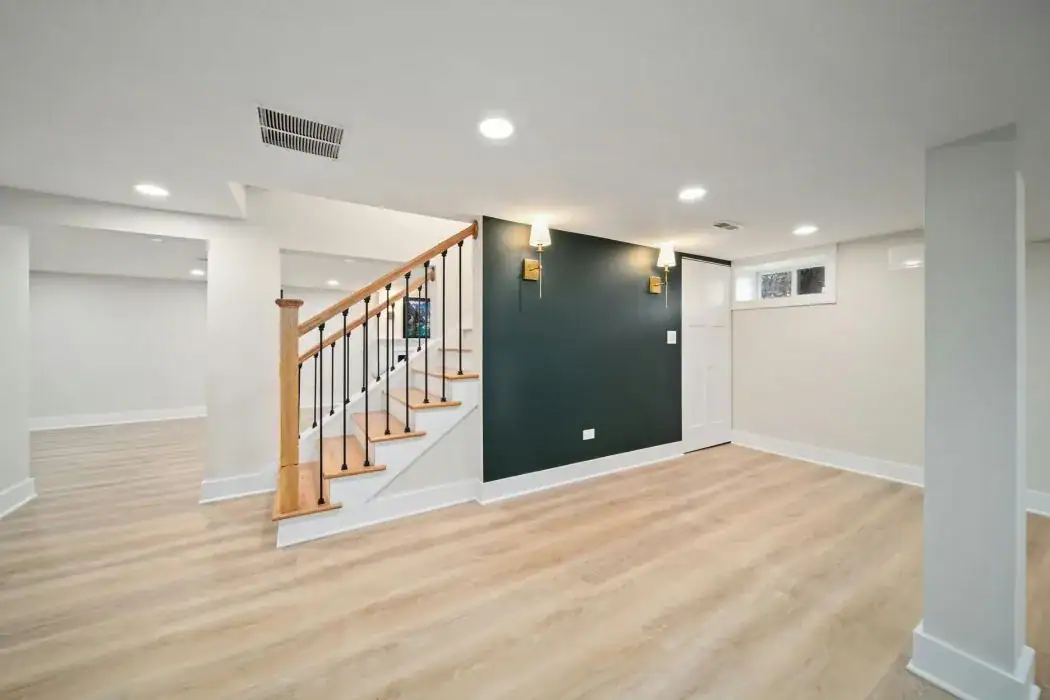 Empty remodeled room with fresh drywall, recessed lights, a staircase and wood-look floor